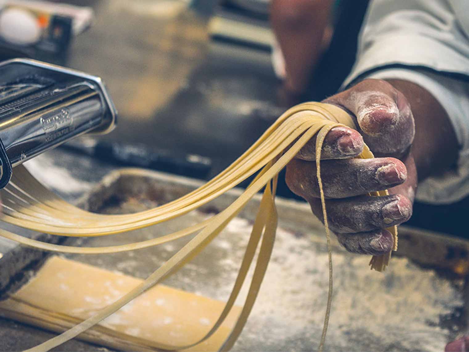 making pasta on our rome cooking class and market visit experience.