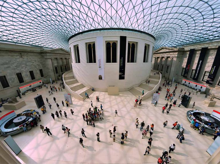 Aerial view of clients enjoying a private tour of the British Museum with their guide.