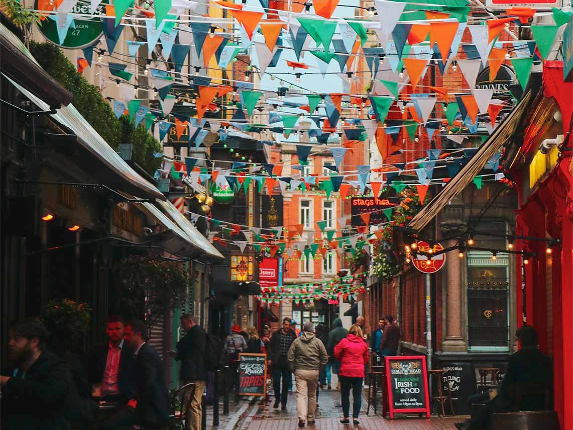 a tour guide and guests enjoying a drink in the temple bar area of dublin.