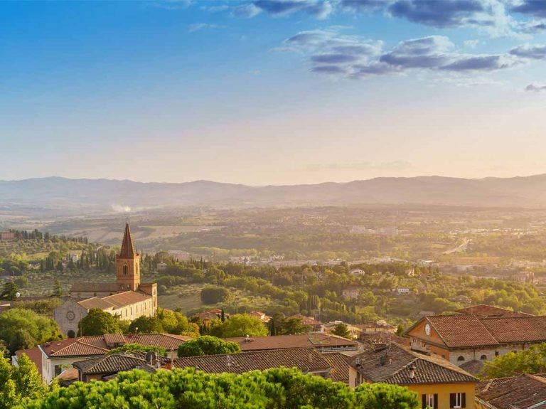 Aerial view of church and sunrise over Perugia in Umbria.