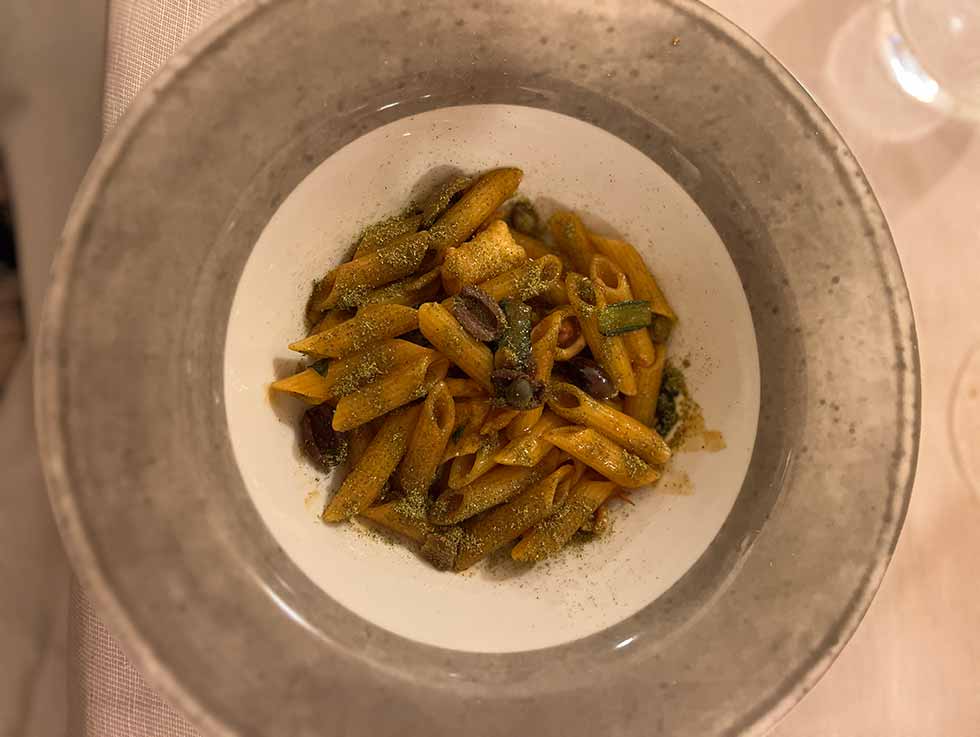 Bowl of freshly cooked pasta served on a Dining Experience, in Italy.