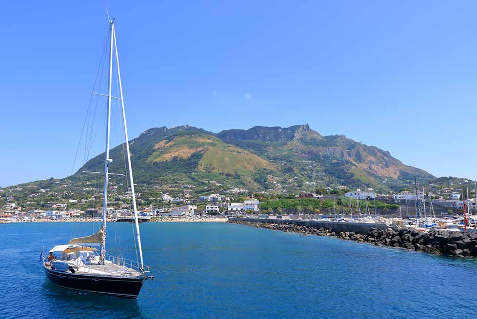 Ischia Boat tour, vessel in foreground with Mount Epomeo in the background.