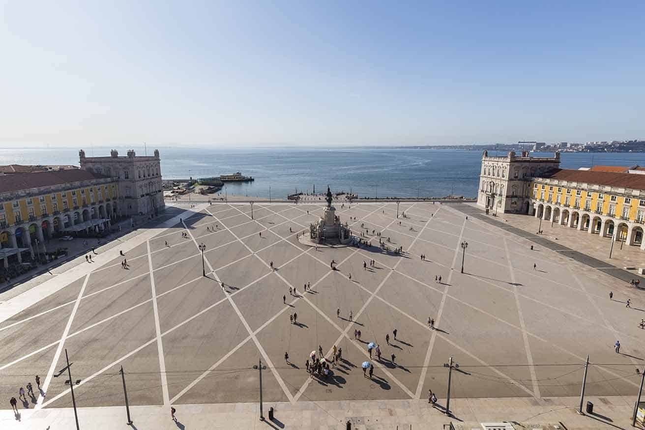 View of Tagus River and people and statue of King Jose I at the Praca do Comercio square in Baixa district in Lisbon, Portugal, from above on a sunny_