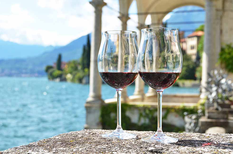 2 wine glasses balanced on historic estate on wine experience tour in Lake Como.