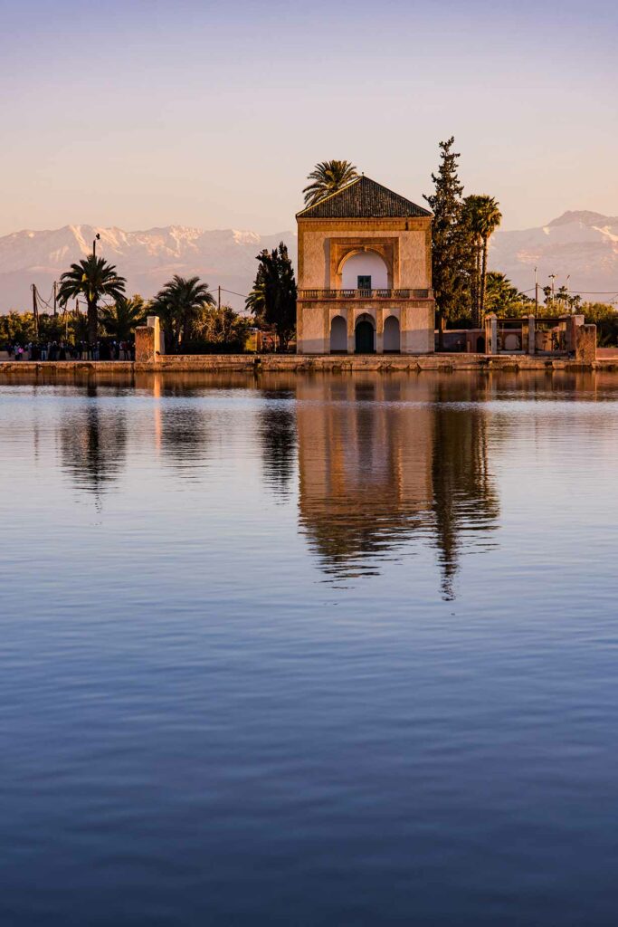 Menara Gardens Pavilion reflect in water at sunset, Morocco