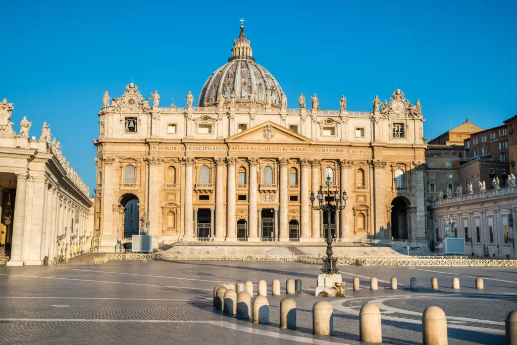 St. Peter's Basilica in Vatican City during a clear sunny day showcasing its Renaissance architecture and historical significance in tourism.