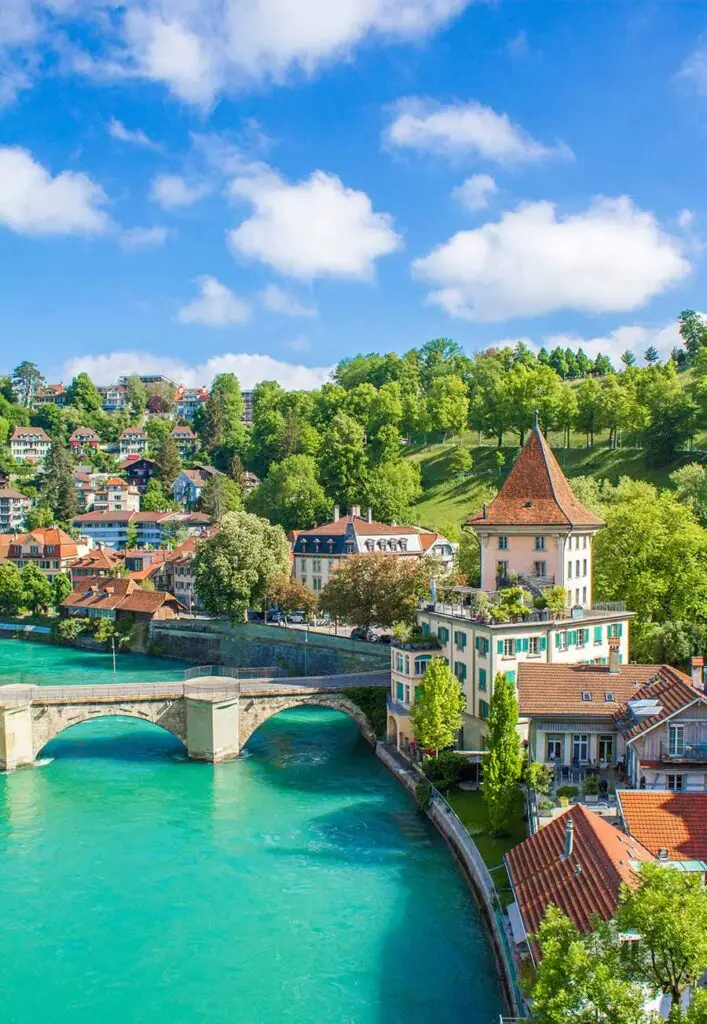 Scenic view of Bern, Switzerland showcasing the historic architecture and turquoise waters of the Aare River.