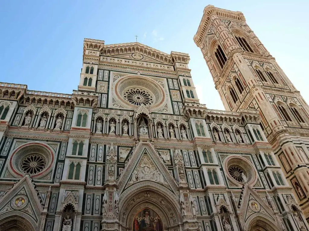 Tourists exploring the intricately detailed facade of Florence Cathedral during a private walking tour in Florence, Italy.
