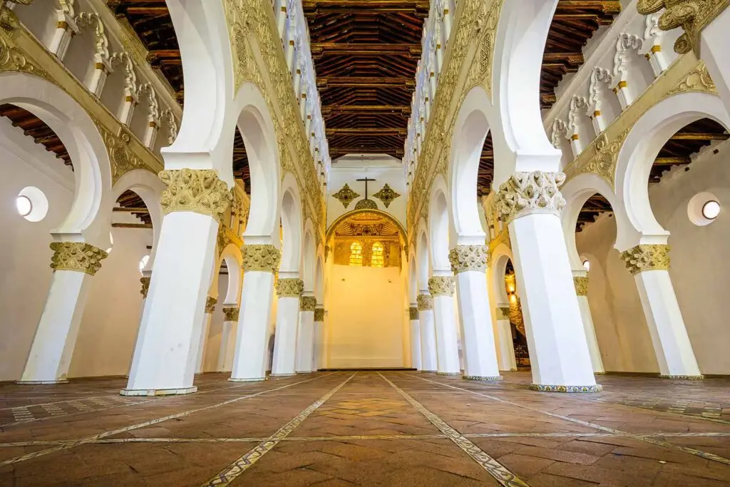Interior view of Santa Maria la Blanca, showcasing its unique Moorish architectural details and ornate design elements in Toledo, Spain.