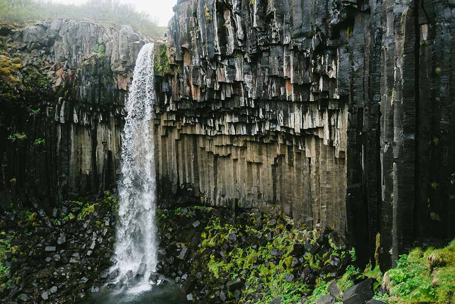 Svartifoss waterfall cascading down basalt columns in Skaftafell, Vatnajökull National Park, Iceland